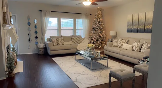 a living room with furniture and a large window