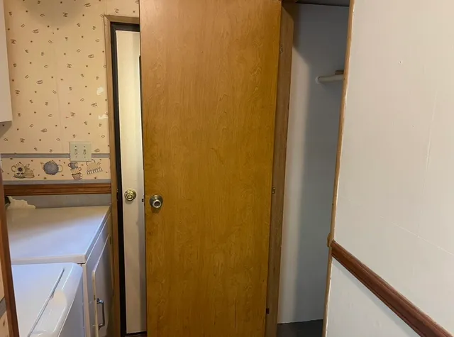 a spacious bedroom with a bed and a chandelier