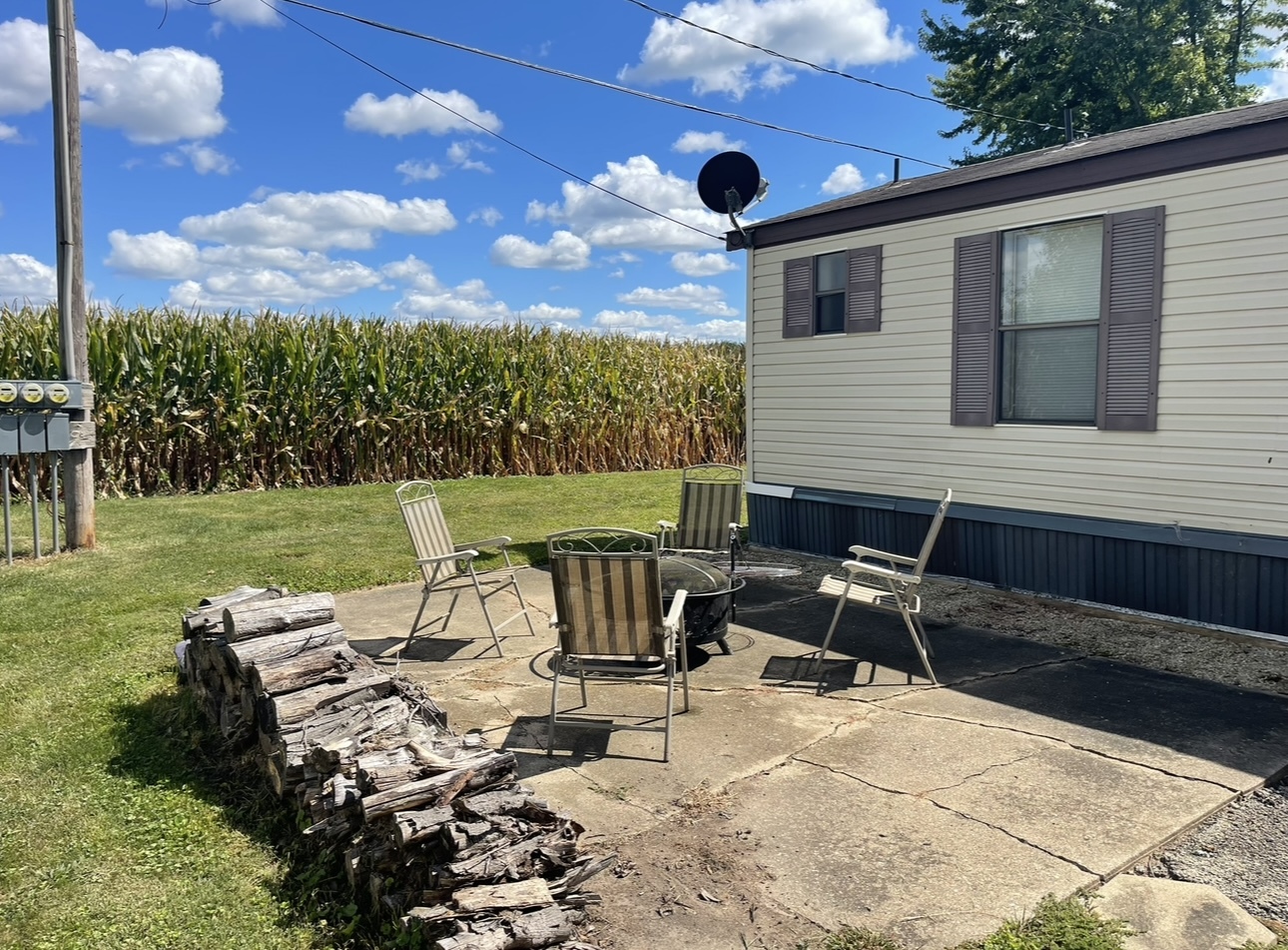 2211 Crestview Drive Princeton, IL 61356 - Photo 23 of 23 a view of a patio with a table chairs and a fire pit
