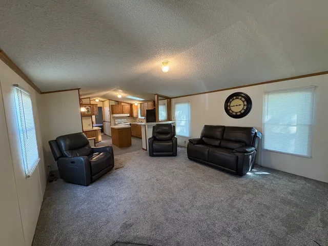 a living room with furniture and a clock