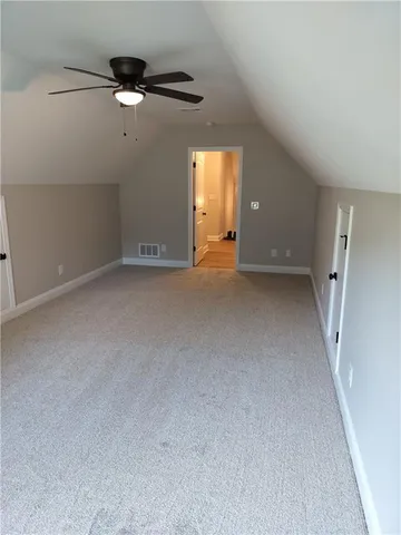 a view of a livingroom with a ceiling fan and window