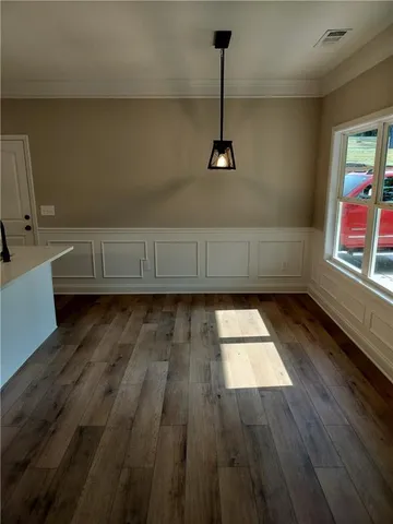 a view of wooden floor and windows in a kitchen