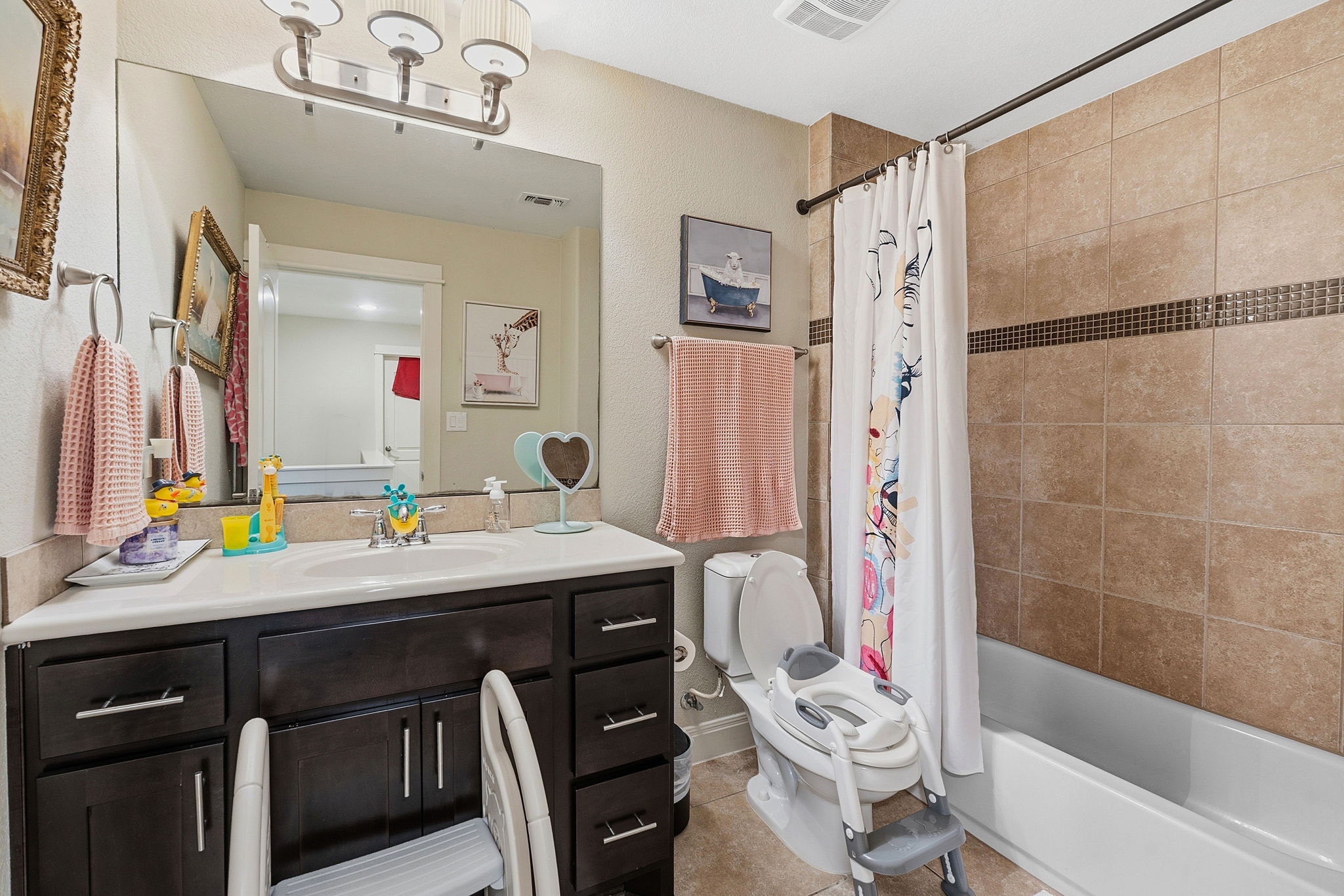 15317 Falconhead Grove Loop Austin, TX 78738 - Photo 23 of 36 Full bathroom featuring a dark wood vanity with white countertop, an integrated sink, and a large wall-mounted mirror