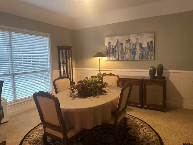 a dining room with furniture and window