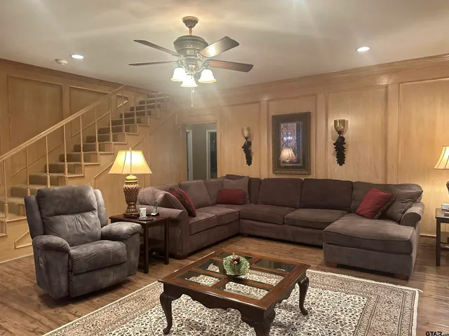 a living room with furniture a chandelier and a window
