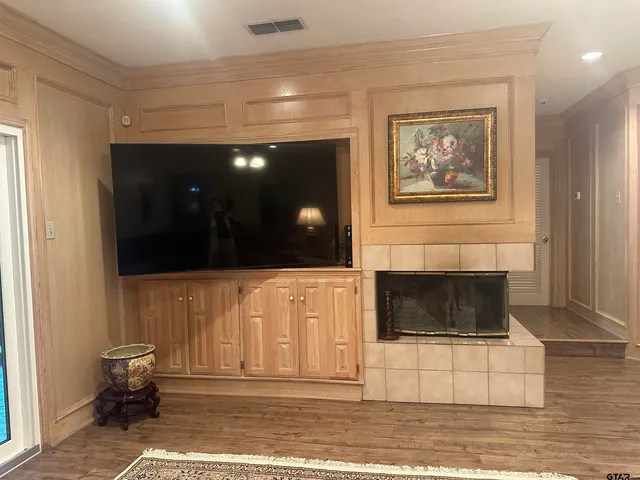 a living room with a fireplace and a rug