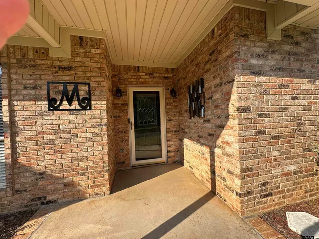a balcony with furniture and a flat screen tv