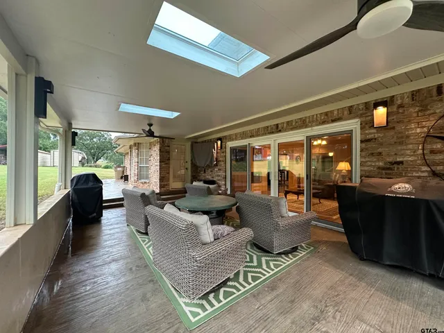 a living room with furniture rug and a large window
