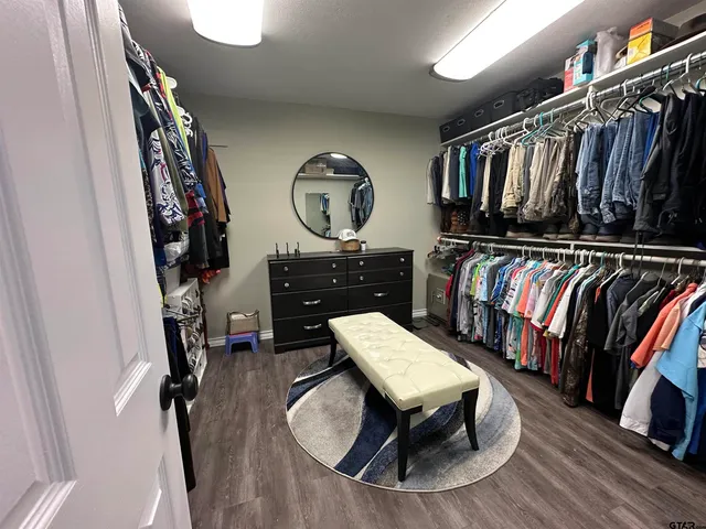 a living room with lots of furniture and wooden floor