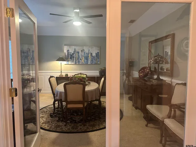 a dining room with furniture and a chandelier