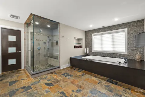 a spacious bathroom with a granite countertop tub shower and sink
