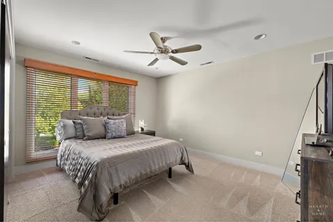 a bedroom with a bed and a ceiling fan