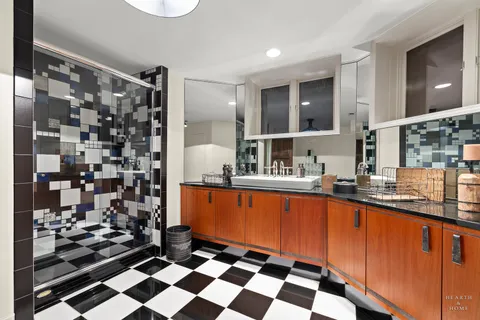 a large kitchen with a sink and cabinets