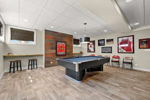 a living room with a flat screen tv and kitchen view
