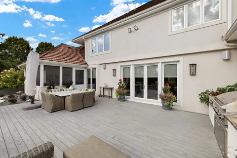 a view of house with a large window and furniture
