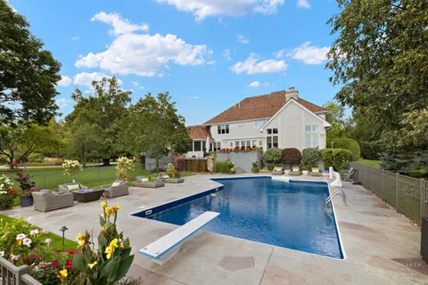 a view of a house with backyard sitting area and garden