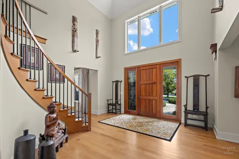 a view of entryway livingroom and hall with wooden floor