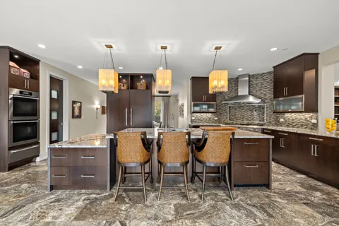 a large kitchen with a table and chairs