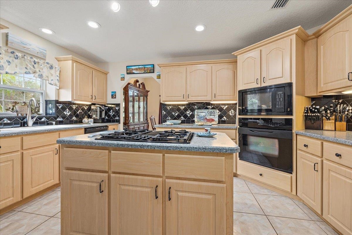3180 B Pacetti Road St. Augustine, FL 32092 - Photo 16 of 42 a kitchen with stainless steel appliances granite countertop a stove a sink and white cabinets
