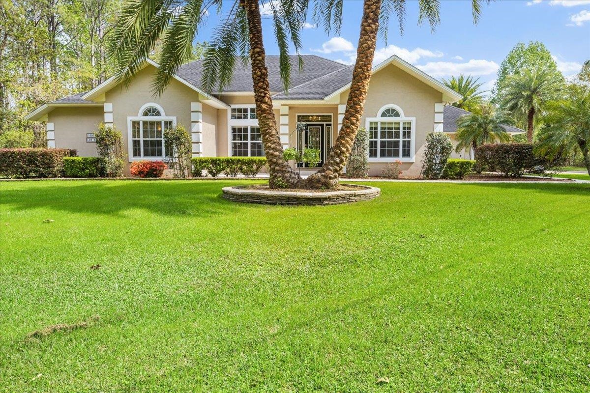 3180 B Pacetti Road St. Augustine, FL 32092 - Photo 2 of 42 a front view of a house with a garden and porch