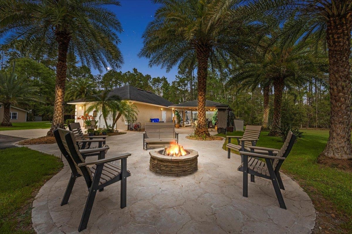 3180 B Pacetti Road St. Augustine, FL 32092 - Photo 25 of 42 a backyard of a house with table and chairs