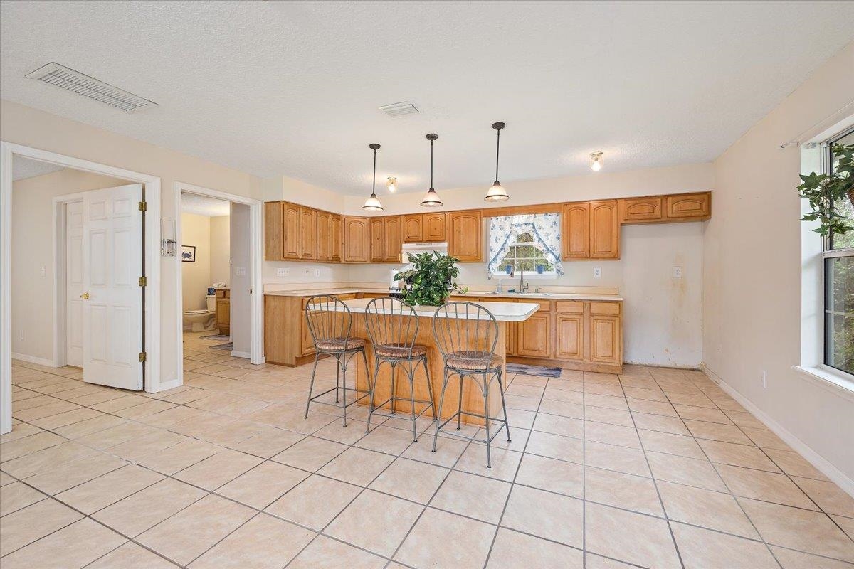 3180 B Pacetti Road St. Augustine, FL 32092 - Photo 30 of 42 a view of a kitchen with furniture and refrigerator