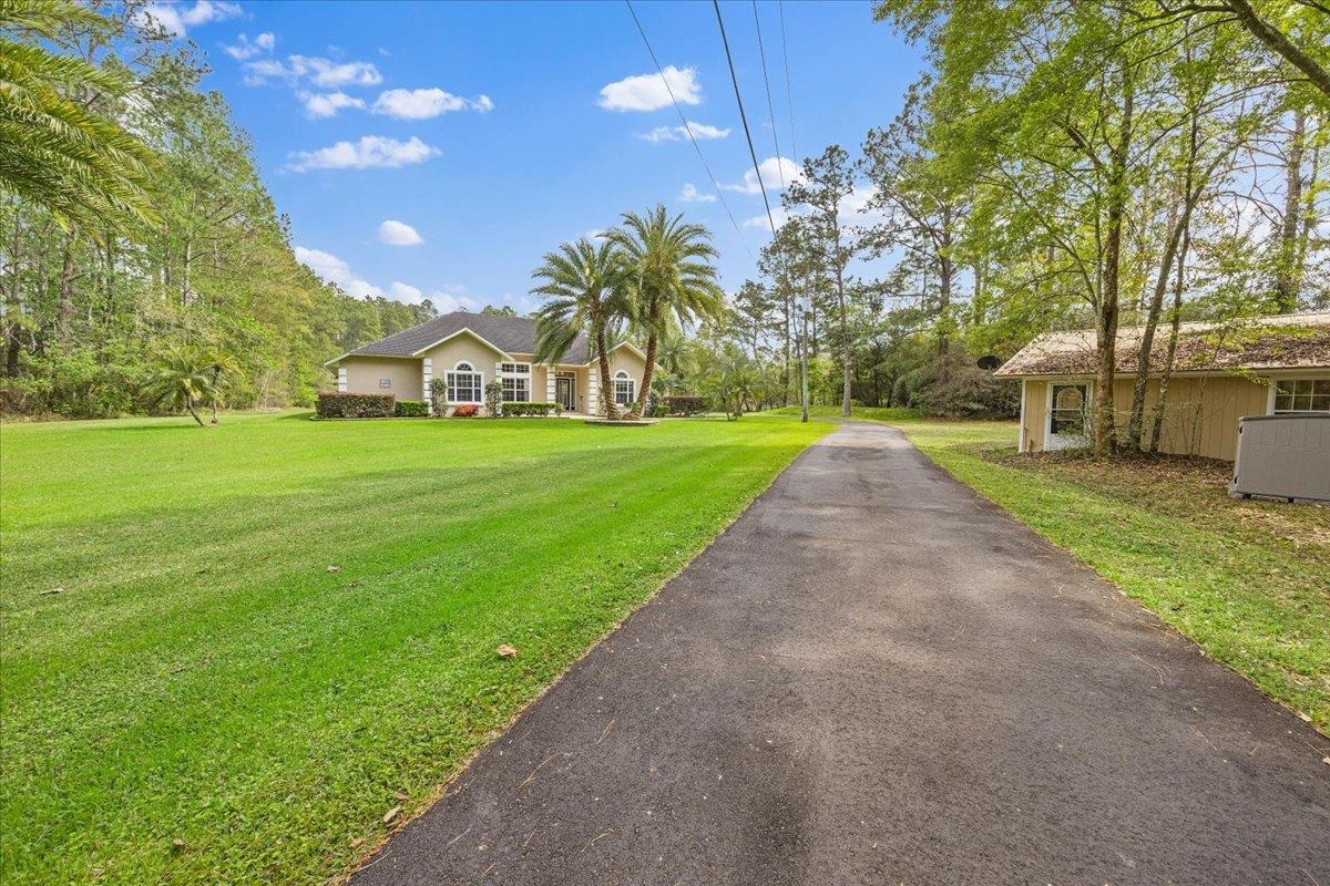 3180 B Pacetti Road St. Augustine, FL 32092 - Photo 35 of 42 a front view of a house with a yard and pathway