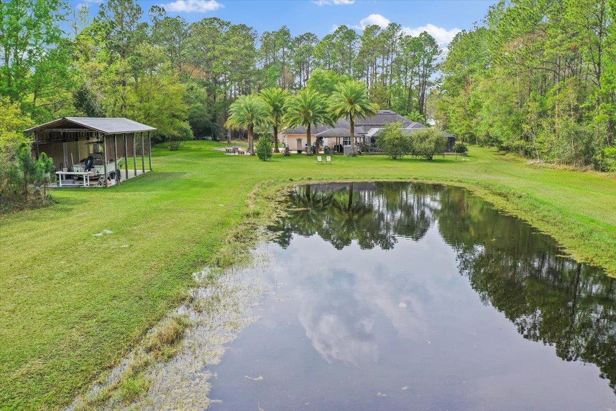 3180 B Pacetti Road St. Augustine, FL 32092 - Photo 38 of 42 a view of a lake with a table and chairs under an umbrella