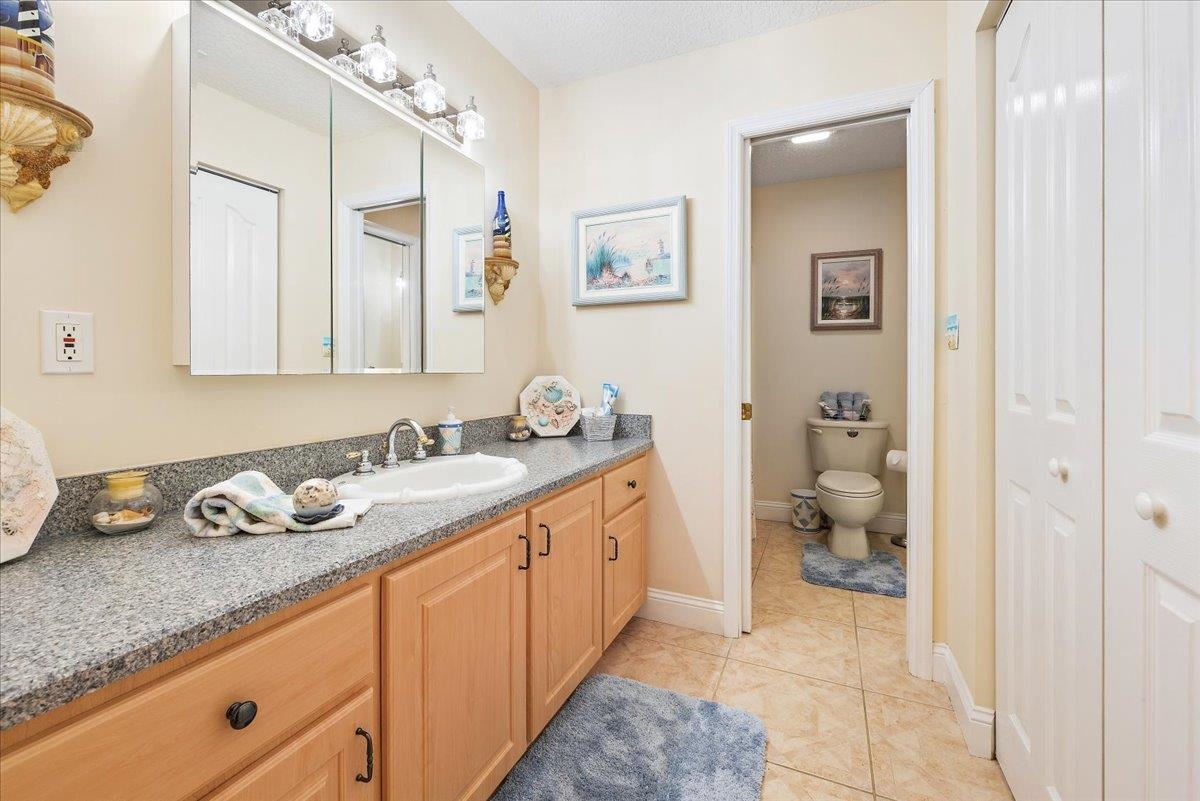 3180 B Pacetti Road St. Augustine, FL 32092 - Photo 41 of 42 a spacious bathroom with a granite countertop sink and a mirror