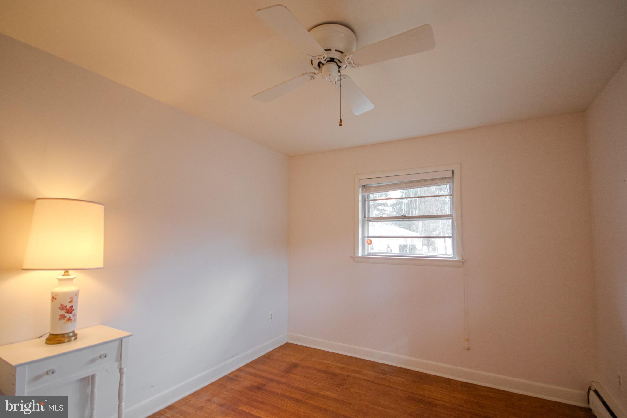 633 Ridge Road Salisbury, MD 21801 - Photo 29 of 45 a view of an empty room with wooden floor and a window