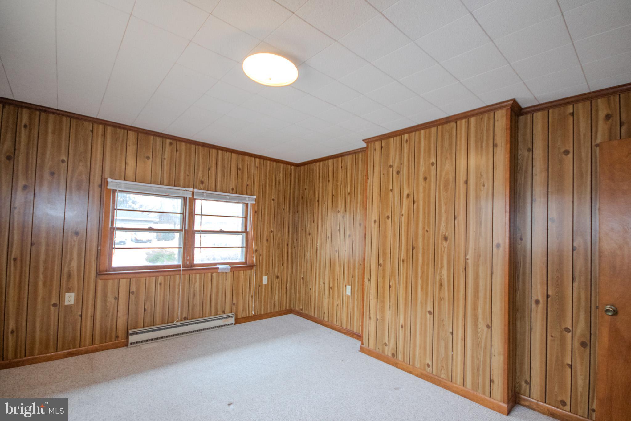 633 Ridge Road Salisbury, MD 21801 - Photo 32 of 45 a view of an empty room with wooden floor and a window