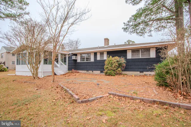 a tall house with trees in front of it