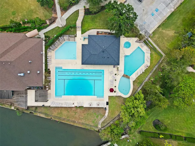 an aerial view of a house with a yard and a fountain
