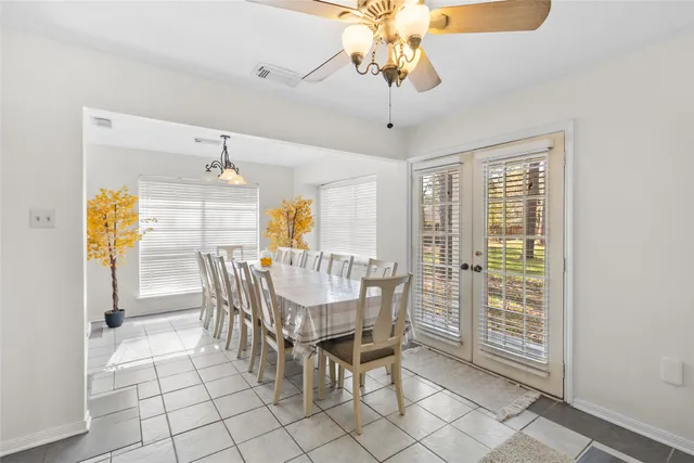 a dining room with furniture a chandelier and window