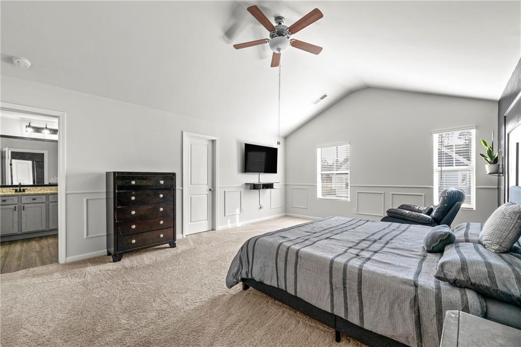 7492 Knoll Hollow Road Lithonia, GA 30058 - Photo 18 of 30 a bedroom with a large bed and a tv