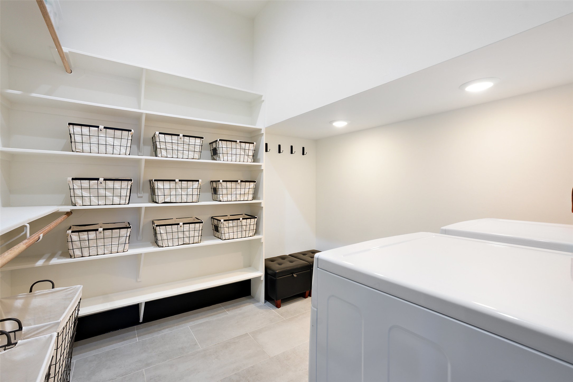 561 Broken Bit Trail Dripping Springs, TX 78620 - Photo 15 of 40 Laundry room with light tile patterned floors, recessed lighting, and washing machine and dryer
