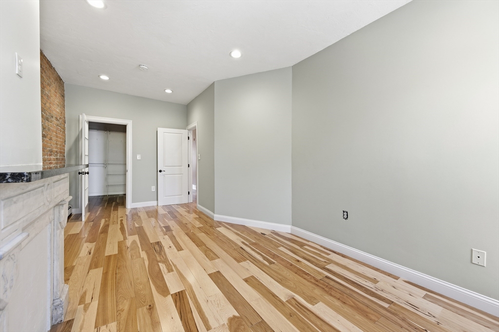 54 Beacon Street, Unit 2 Chelsea, MA 02150 - Photo 17 of 26 a view of a bedroom with a bed and wooden floor