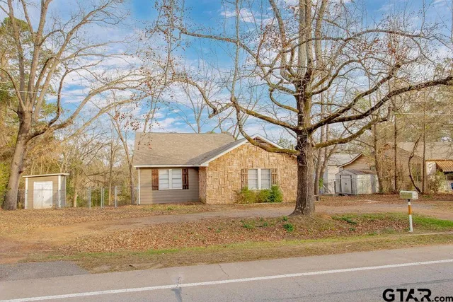 a view of a yard with a house and a tree