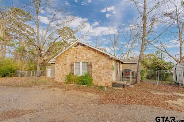 a view of a large house with a large tree