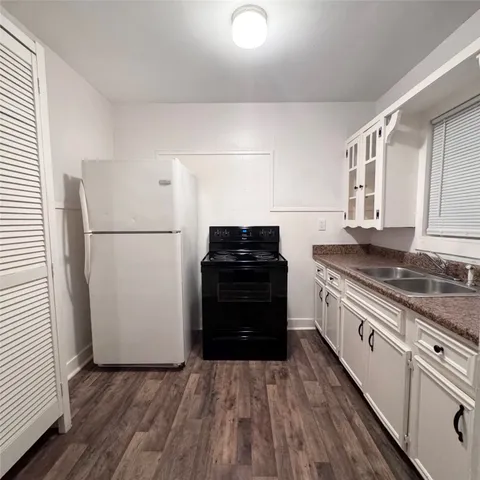 a kitchen with a refrigerator and a stove
