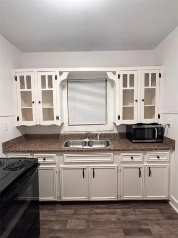 a kitchen with stainless steel appliances granite countertop a sink and stove top oven
