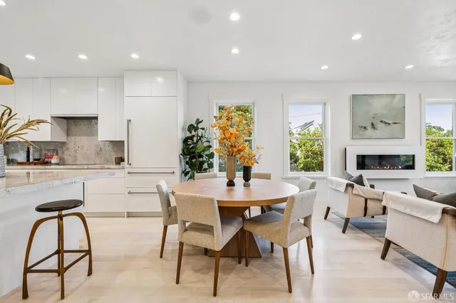 a dining room with furniture a window and a kitchen