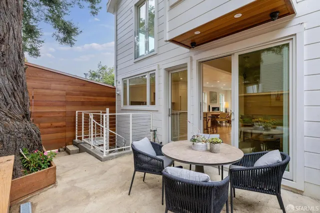 a view of a patio with table and chairs and potted plants