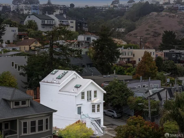 an aerial view of residential houses with outdoor space
