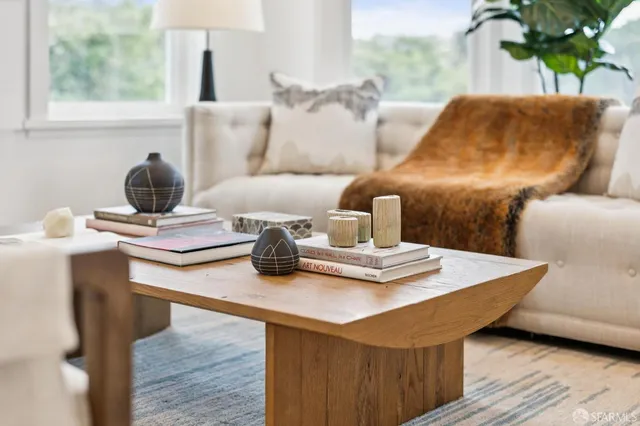 a living room with furniture and a potted plant