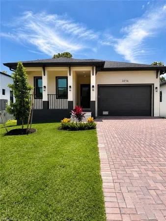 a front view of a house with garden