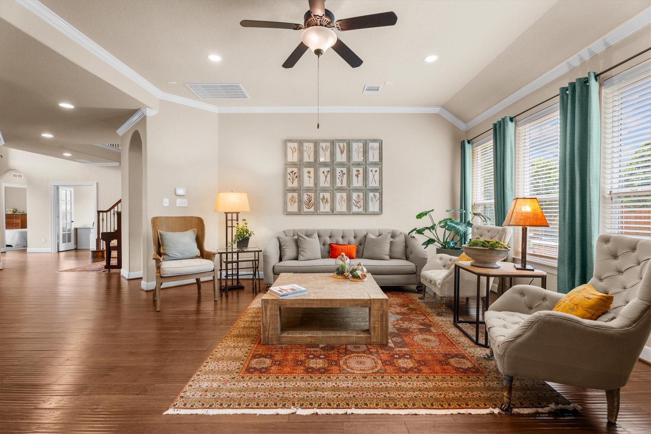 3 Indigo Bunting Place Spring, TX 77389 - Photo 17 of 41 This living room is spacious and inviting. Large windows with curtains provide ample natural light, while a ceiling fan and warm lighting add comfort.