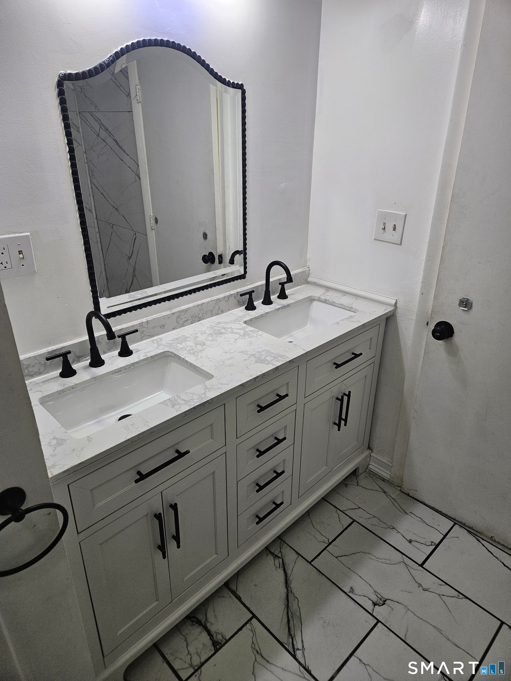 236 Brooks Street, Unit 236 Bridgeport, CT 06608 - Photo 4 of 12 a bathroom with a double vanity sink and mirror