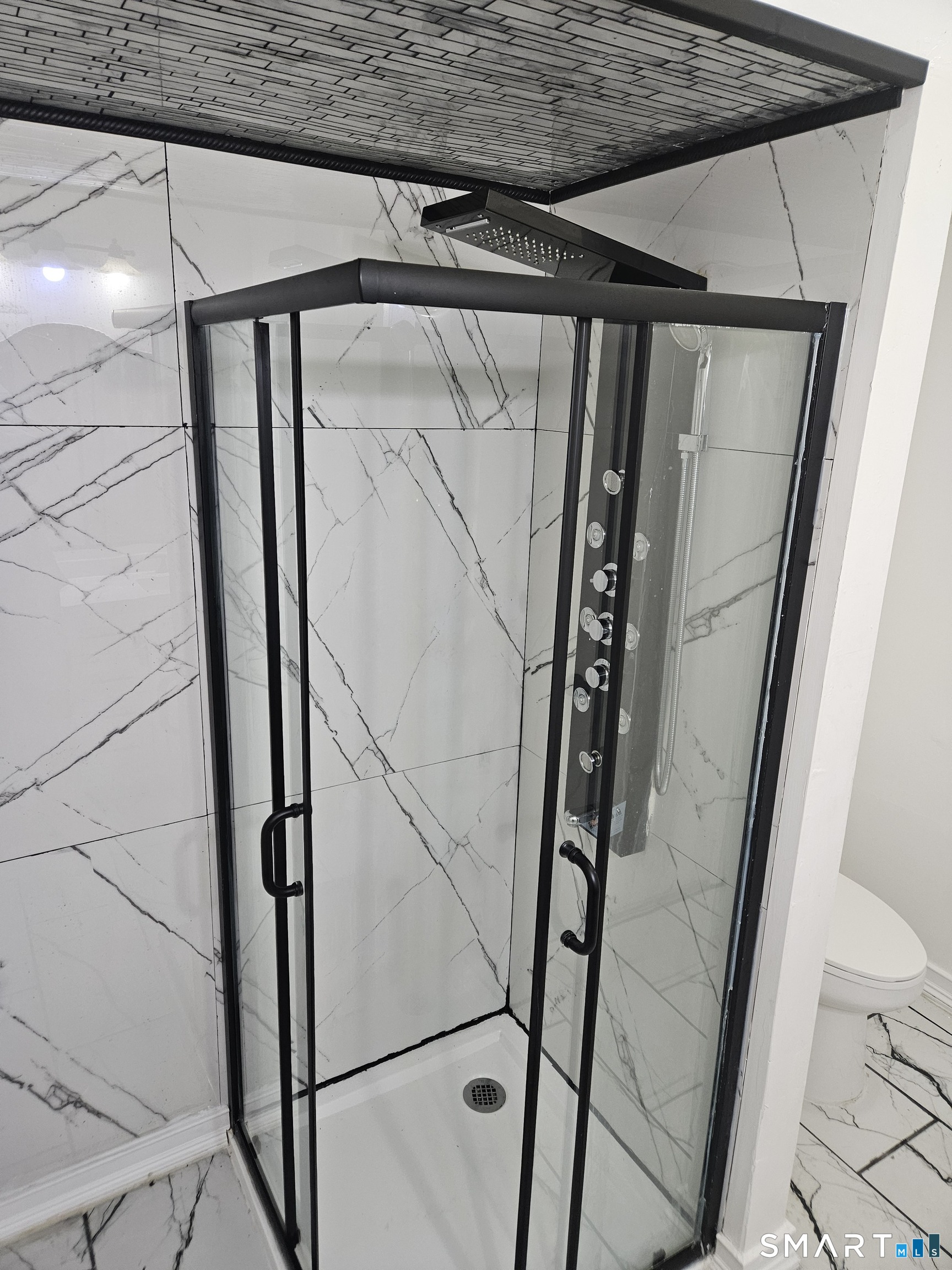 236 Brooks Street, Unit 236 Bridgeport, CT 06608 - Photo 5 of 12 a bathroom with a glass door shower and vanity