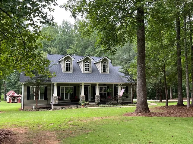 a front view of a house with a garden